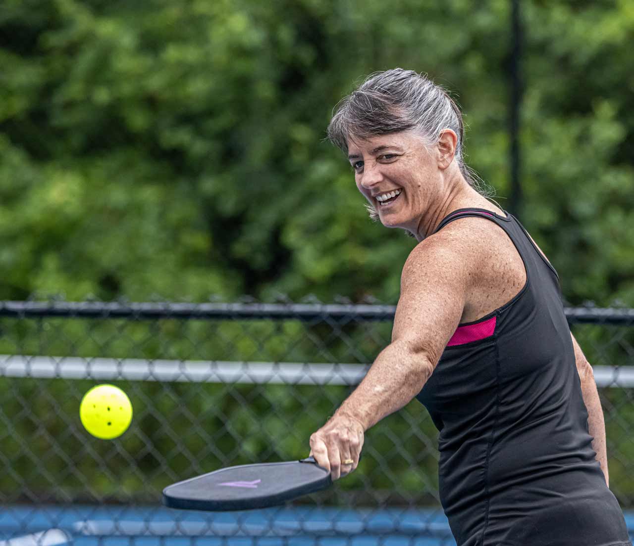 A woman playing pickleball<br />
